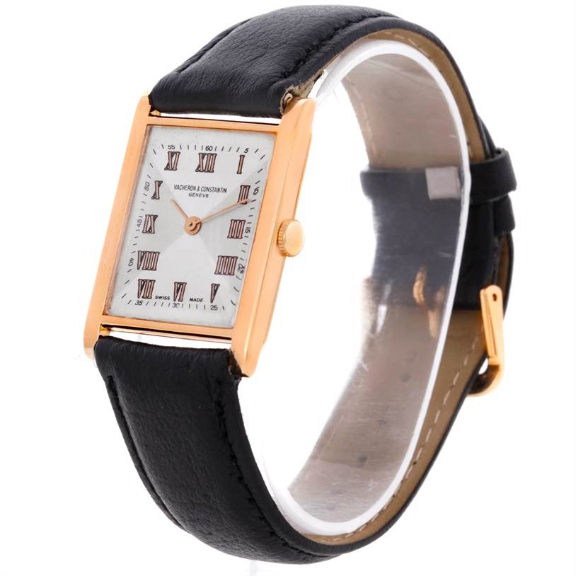 The image shows a Vintage Vacheron Constantin watch at an angle highlighting its rectangular dial, gold case, and black leather strap.