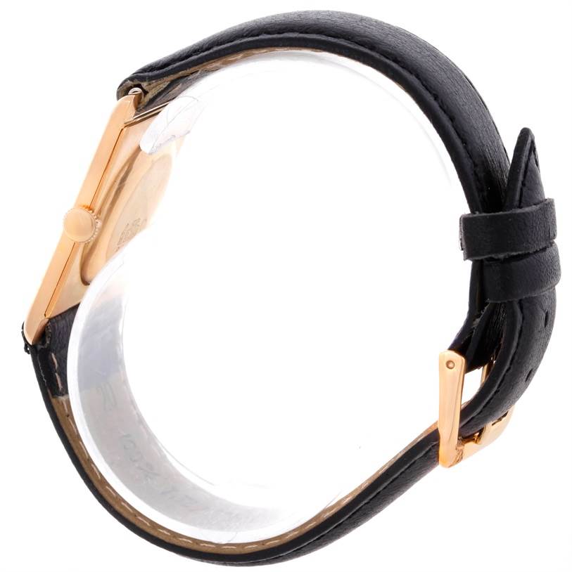 The image shows a side view of a Vintage model watch by Vacheron Constantin, highlighting its black leather strap and gold case.