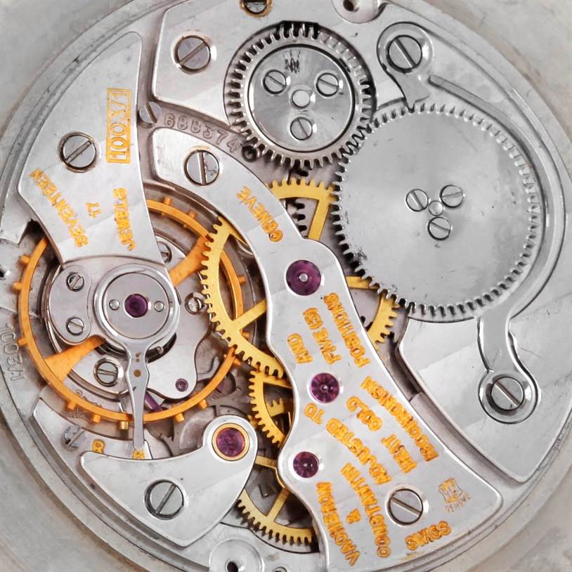 The image shows an overhead view of the intricate internal mechanism of a Vintage Vacheron Constantin watch.