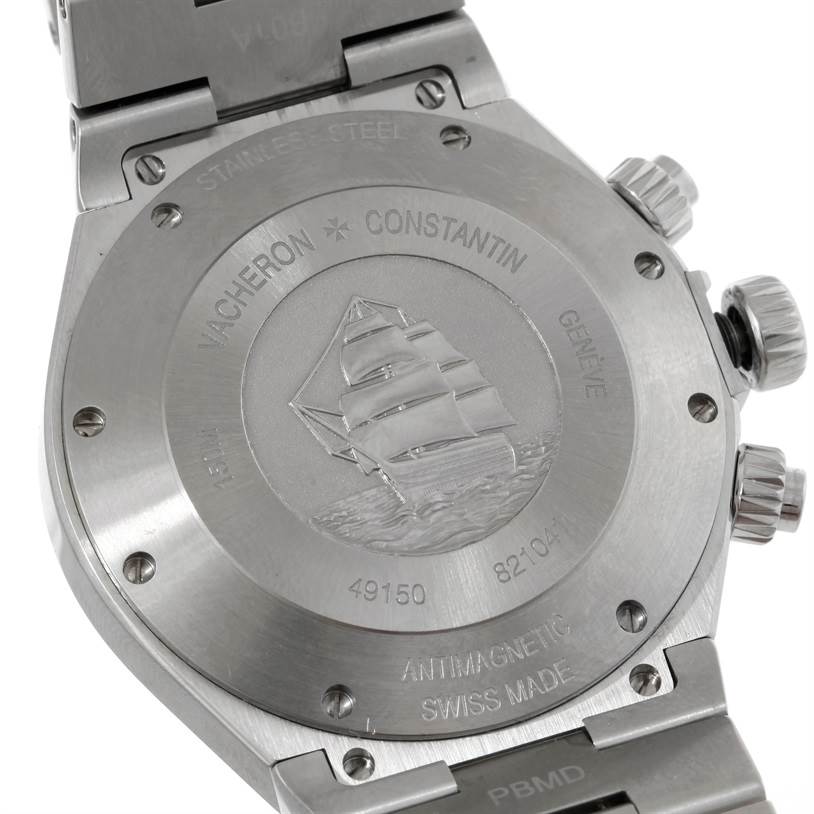 This image shows the back case of the Vacheron Constantin Overseas 49150.B01A.9097 Men's Stainless Steel Black Dial 49150.B01A.9097 Men's Stainless Steel Black Dial watch, revealing detailed engravings and the stainless steel bracelet attachment.