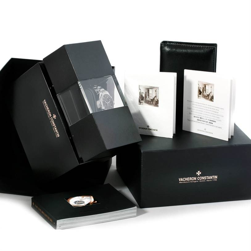 The image shows a Vacheron Constantin Overseas 49150.B01A.9097 Men's Stainless Steel Black Dial 49150.B01A.9097 Men's Stainless Steel Black Dial watch in its box, accompanied by manuals and warranty documents at an angle.