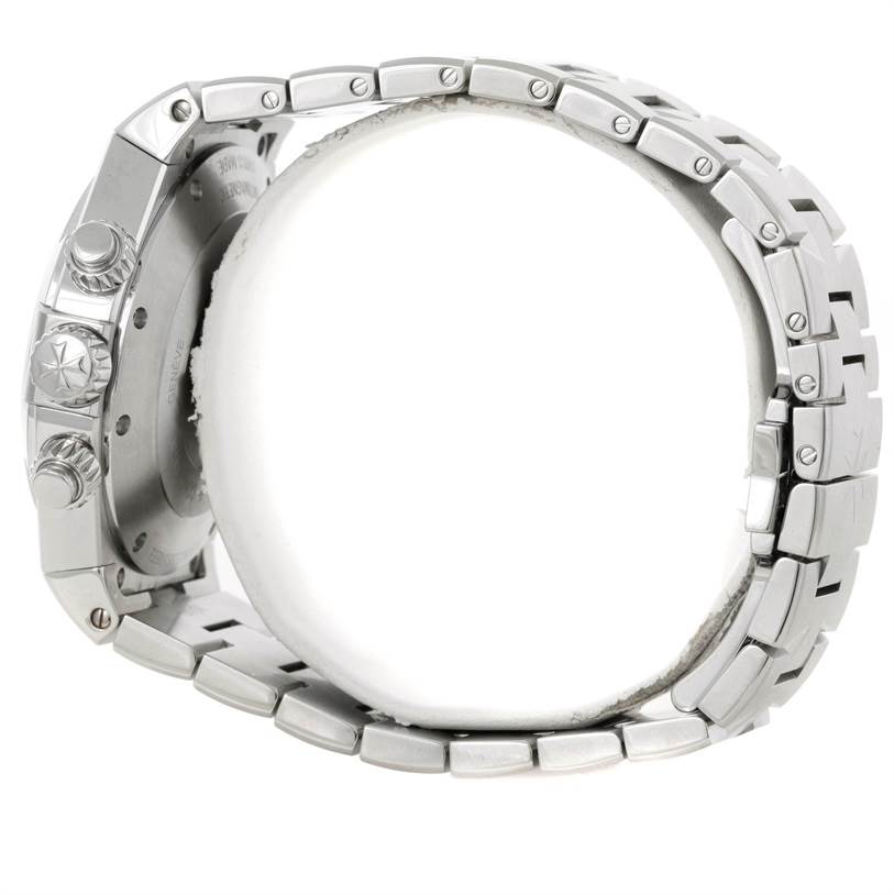 The image shows a side view of the Vacheron Constantin Overseas 49150.B01A.9097 Men's Stainless Steel Black Dial 49150.B01A.9097 Men's Stainless Steel Black Dial watch, highlighting the crown, pushers, and part of the metal bracelet.