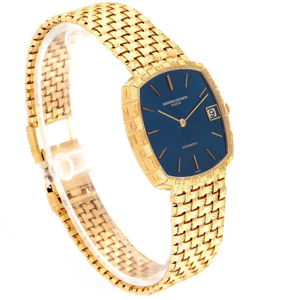The image shows a side angle of a Vacheron Constantin Vintage 7664 Men's Yellow Gold Blue Dial 7664 Men's Yellow Gold Blue Dial watch, highlighting its blue dial, gold case, and gold woven bracelet.