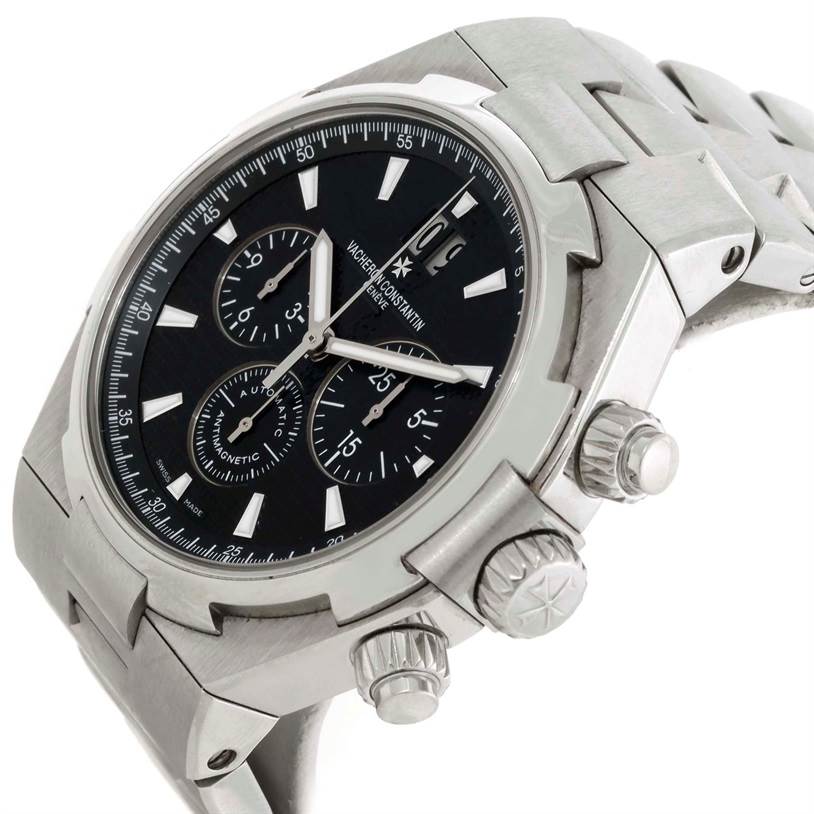 The image shows a close-up side angle of the Vacheron Constantin Overseas 49150.B01A.9097 Men's Stainless Steel Black Dial 49150.B01A.9097 Men's Stainless Steel Black Dial model watch, highlighting its crown, pushers, and black dial.