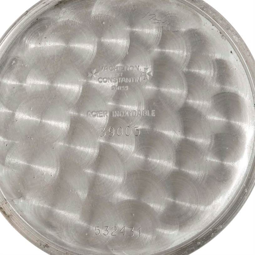 The image shows the inside case back of a Vintage Vacheron Constantin watch, highlighting serial numbers and the "acier inoxydable" engraving.