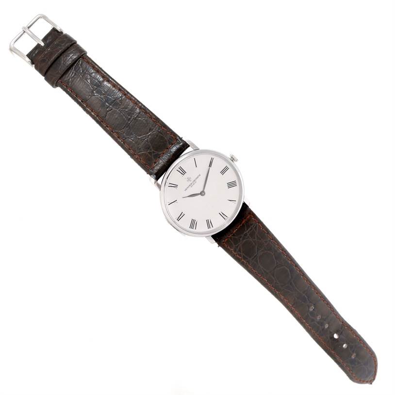 The image shows a top-down view of a Vintage Vacheron Constantin watch with a leather strap and a round white dial.