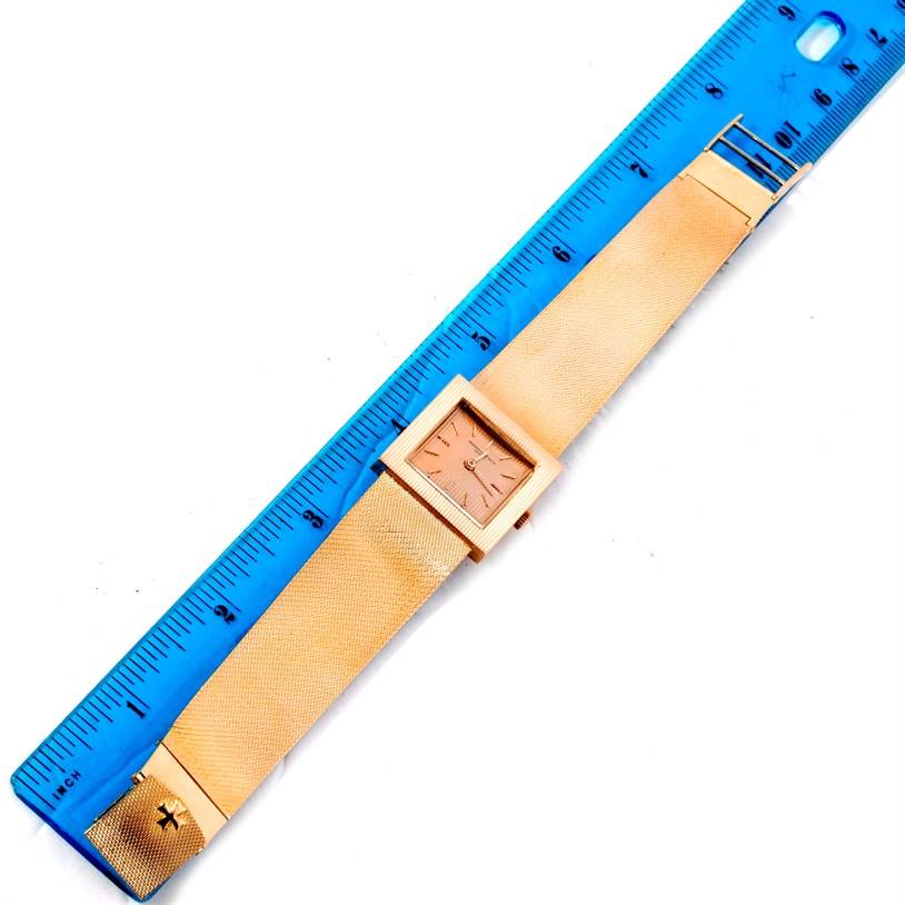 This image shows the entire Vintage Vacheron Constantin watch laid flat next to a blue ruler, highlighting its dimensions.