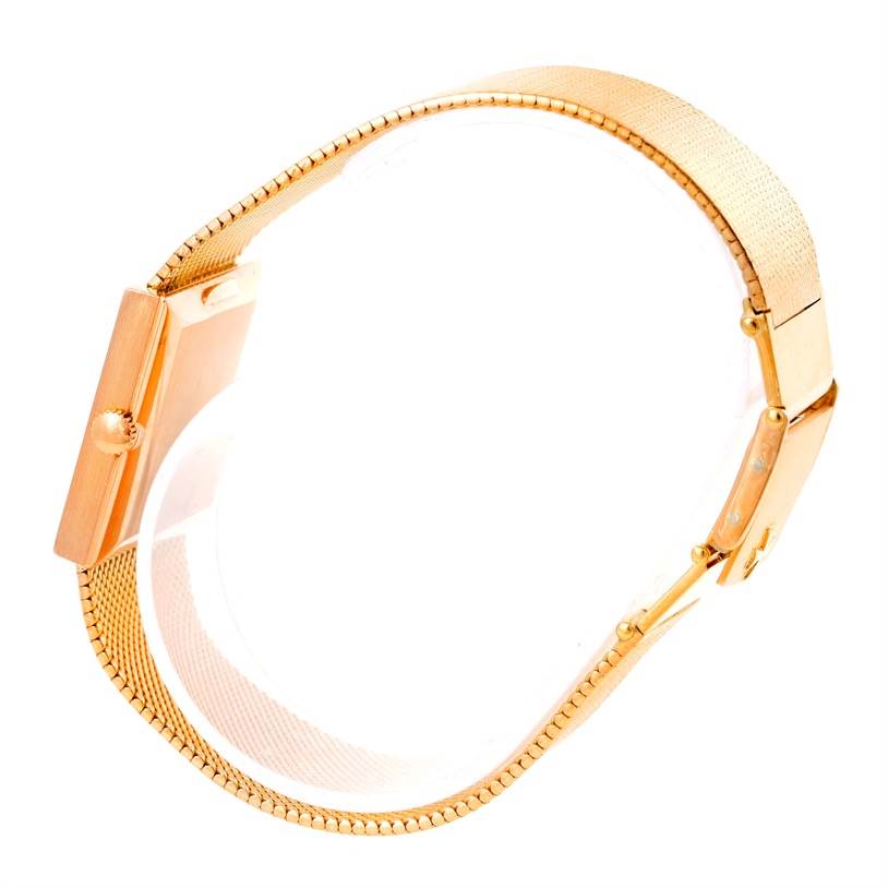 The image shows a side view of a vintage Vacheron Constantin watch, highlighting its gold case and matching mesh strap.