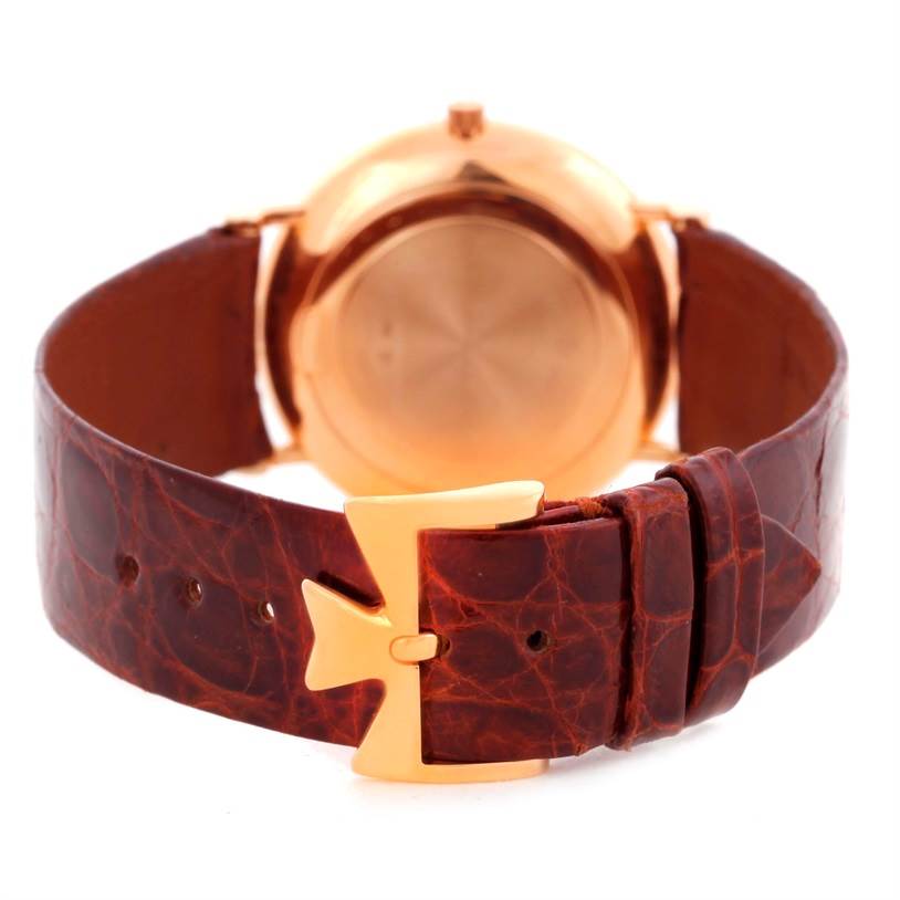 The image shows the back view of a Vacheron Constantin Patrimony 39005 Men's Rose Gold White Dial 39005 Men's Rose Gold White Dial watch, highlighting its case back and brown leather strap with a distinctive clasp.