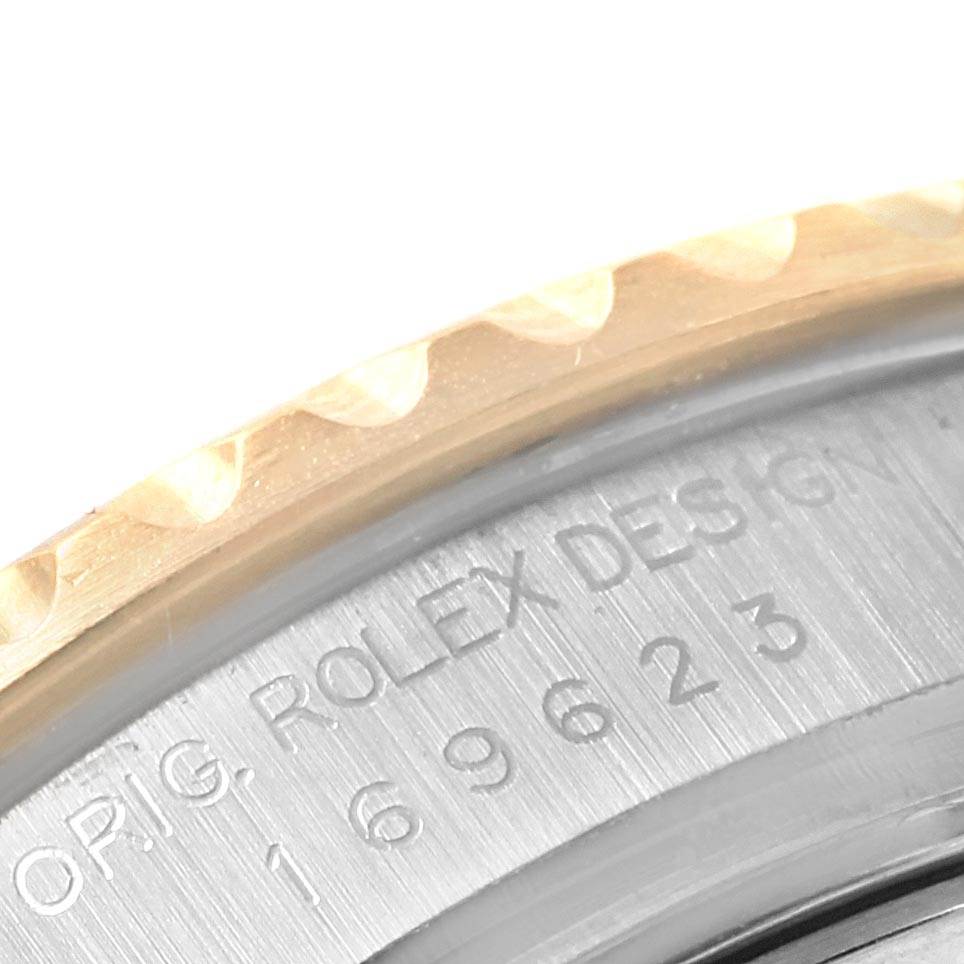 The image shows a close-up of the case back engraving and part of the bezel of a Rolex Yacht-Master 169623 Women
s Steel and Gold (two tone) White Dial 169623 Women
s Steel and Gold (two tone) White Dial watch.