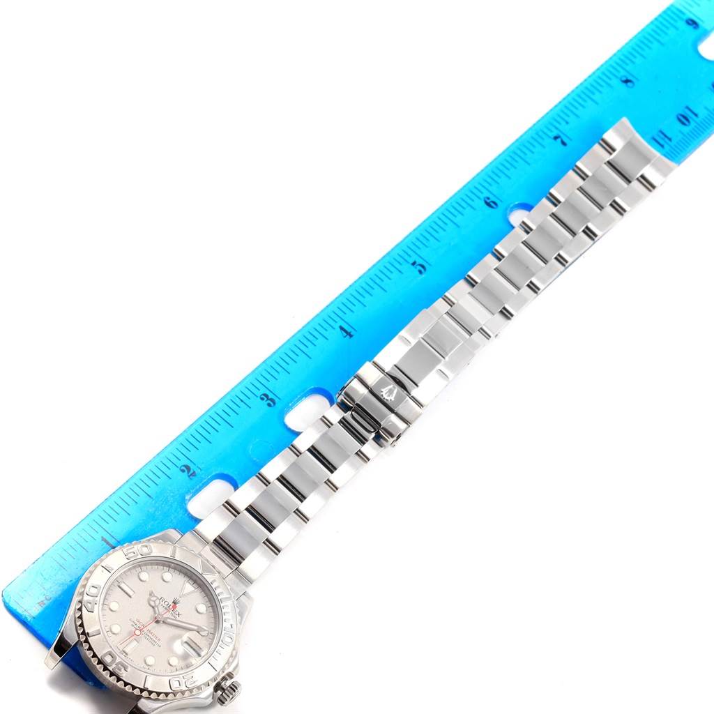 The image shows a Rolex Yacht-Master 168622 Stainless Steel Silver Dial 168622 Stainless Steel Silver Dial watch laid flat with a metal bracelet next to a blue ruler for scale.