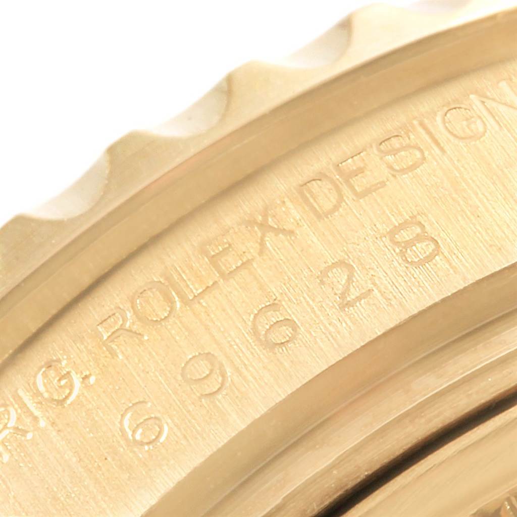 The image shows an angled close-up of the Rolex Yacht-Master 69628 Women's Yellow Gold Mother of Pearl Dial 69628 Women's Yellow Gold Mother of Pearl Dial's bezel and engraved text on its side.