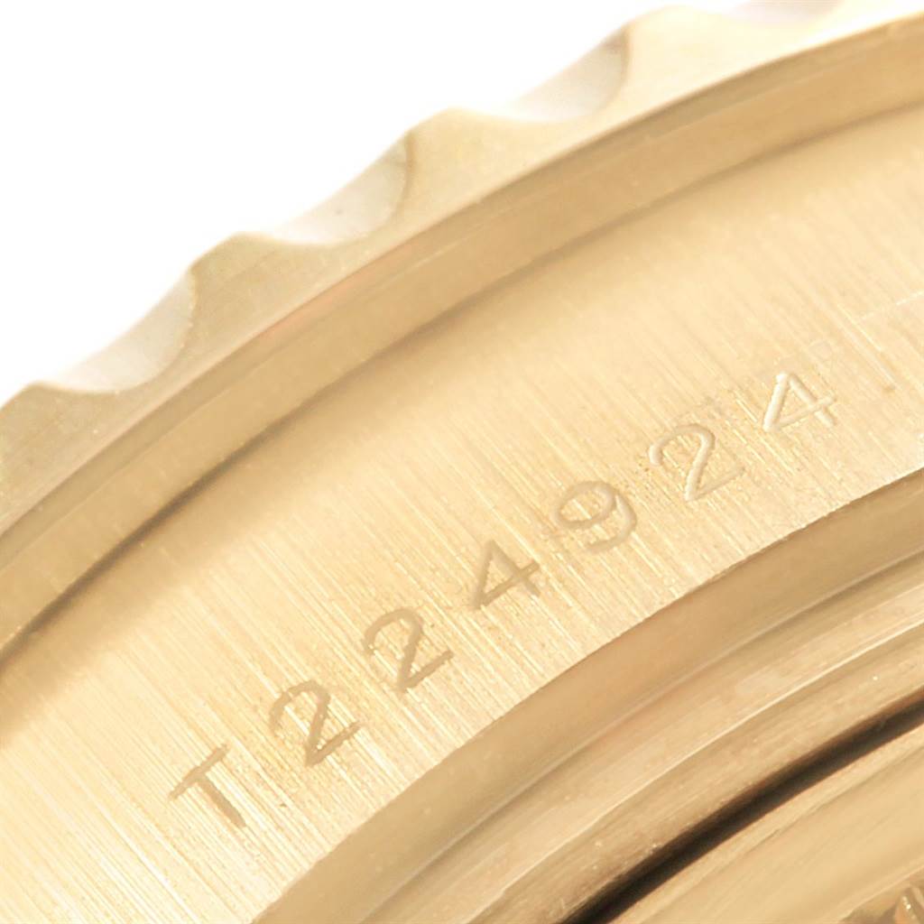 The image shows a close-up of the bezel and case of a Rolex Yacht-Master 69628 Women's Yellow Gold Mother of Pearl Dial 69628 Women's Yellow Gold Mother of Pearl Dial watch, highlighting the engraved serial number.