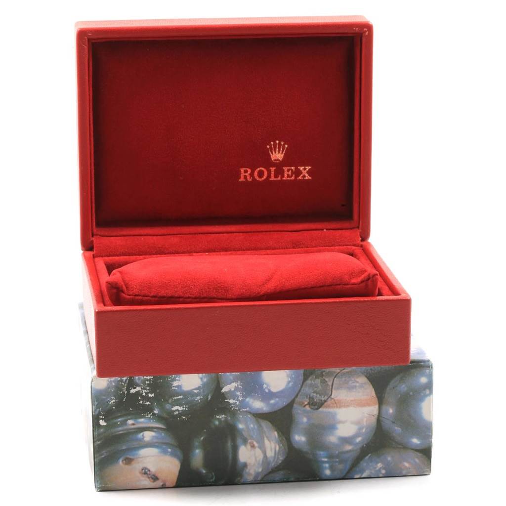 This image shows an open red Rolex watch box, likely for a Yacht-Master model, with a cushion inside.