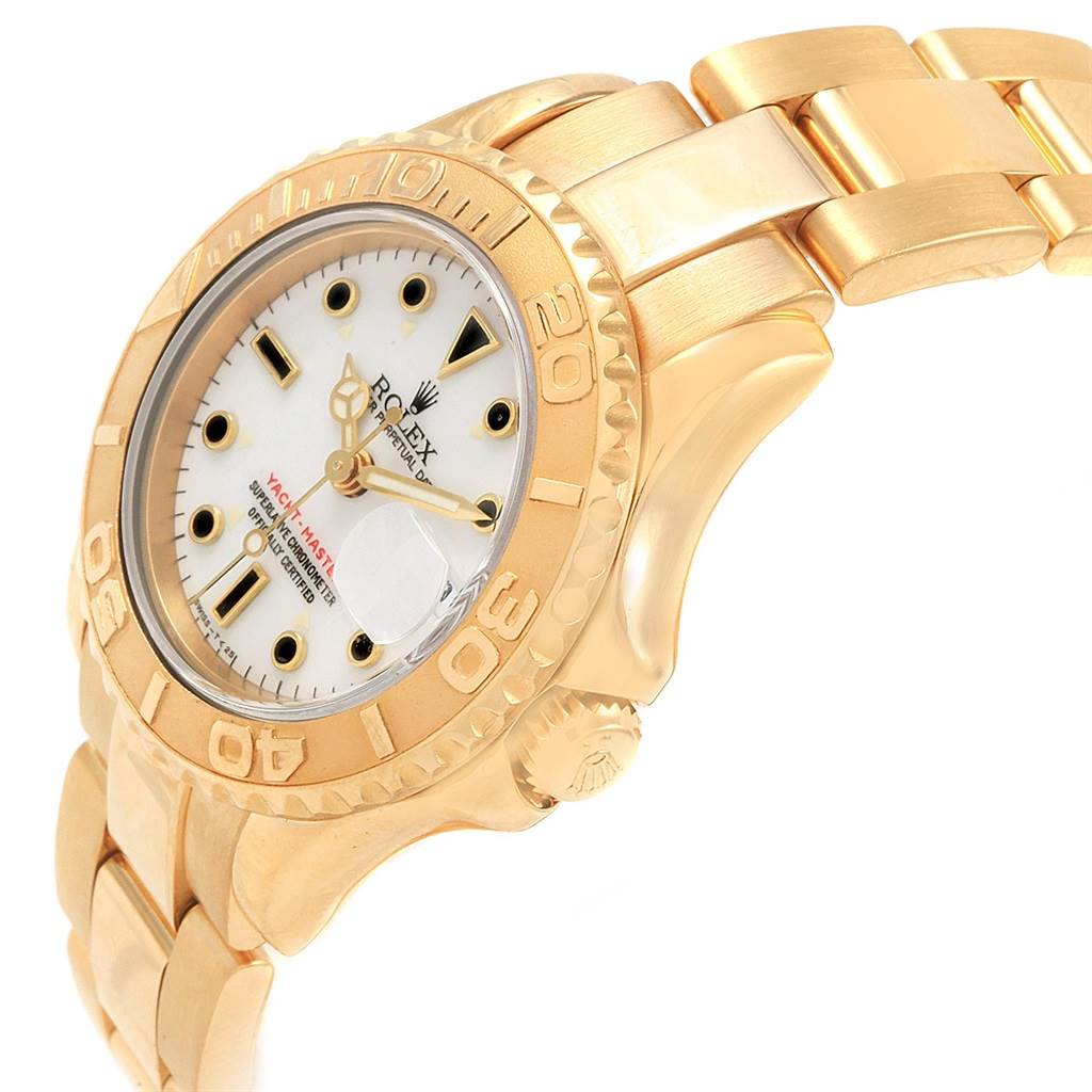 This image shows a gold Rolex Yacht-Master 69628 Women's Yellow Gold White Dial 69628 Women's Yellow Gold White Dial watch at an angled view, highlighting its face, bezel, and part of the bracelet.
