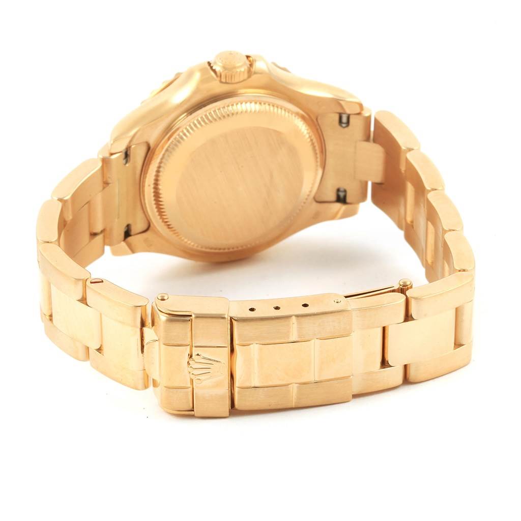 This image shows the back case, crown, and bracelet clasp of a Rolex Yacht-Master 69628 Women's Yellow Gold White Dial 69628 Women's Yellow Gold White Dial watch, in a gold finish, from a rear angle.