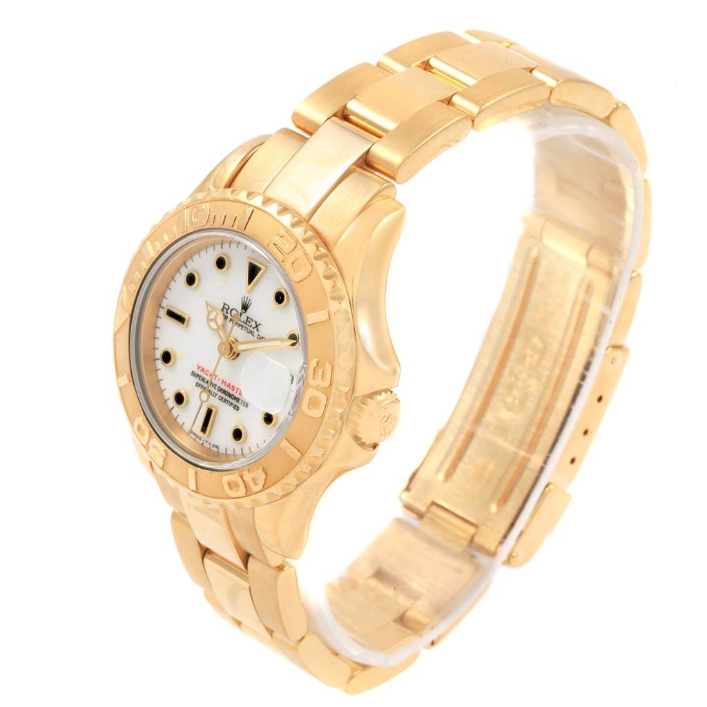 The Rolex Yacht-Master 69628 Women's Yellow Gold White Dial 69628 Women's Yellow Gold White Dial watch is shown at a three-quarter angle, displaying its gold case, bracelet, dial, and bezel.