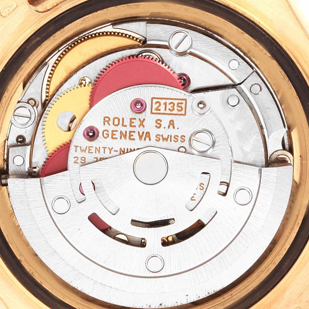 The image shows a close-up of the Rolex Yacht-Master 69628 Women's Yellow Gold White Dial 69628 Women's Yellow Gold White Dial watch's internal mechanism, highlighting gears and inscriptions.
