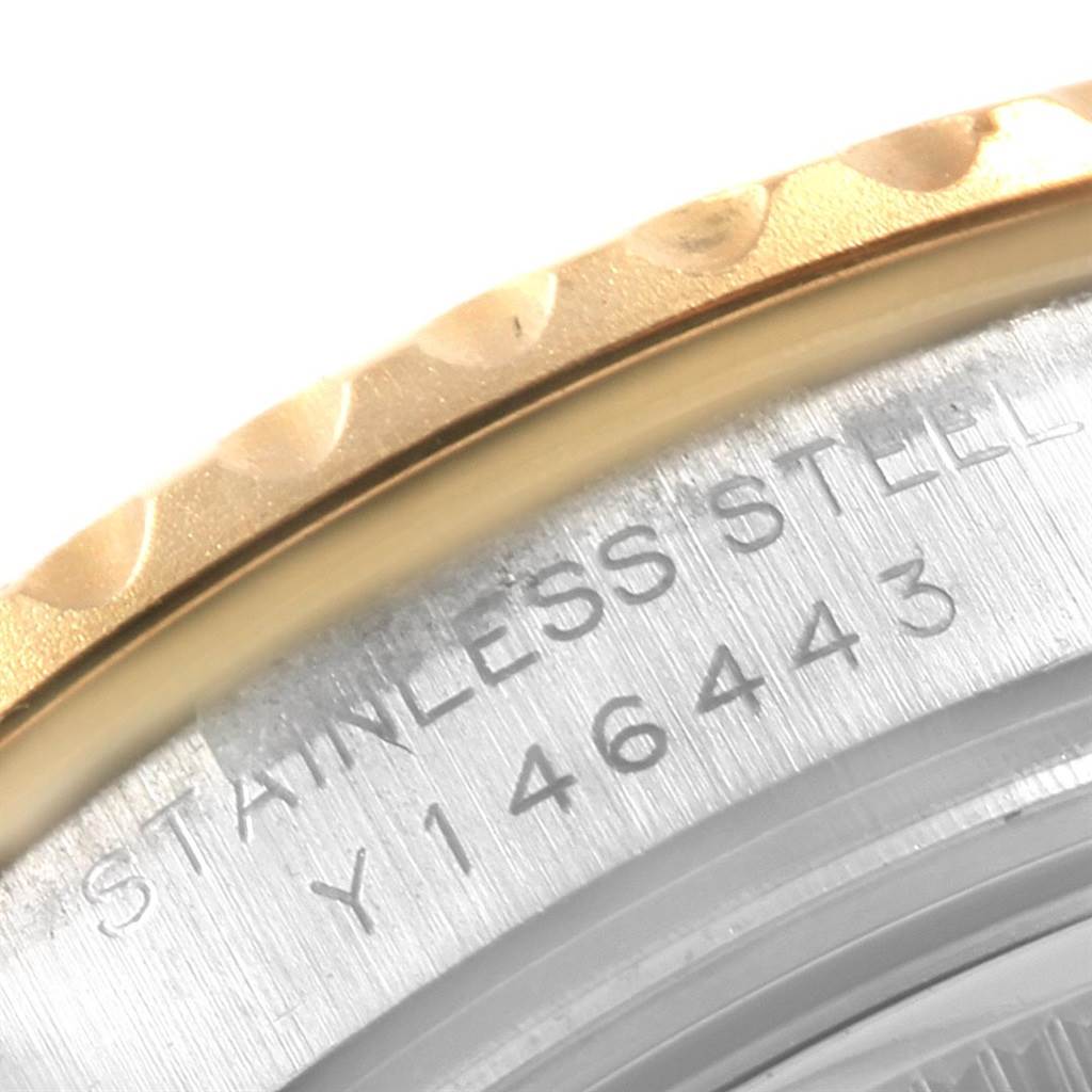 This image shows a close-up angle of the case back's edge and the outer rim of a Rolex Yacht-Master 169623 Women's Steel and Gold (two tone) Mother of Pearl Dial 169623 Women's Steel and Gold (two tone) Mother of Pearl Dial watch, displaying part of its stainless steel casing.