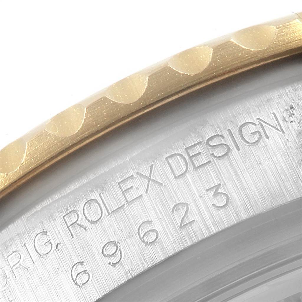 This close-up image shows the edge of the bezel and the engraved serial number on the Rolex Yacht-Master 69623 Women's Steel and Gold (two tone) Grey Dial 69623 Women's Steel and Gold (two tone) Grey Dial watch.