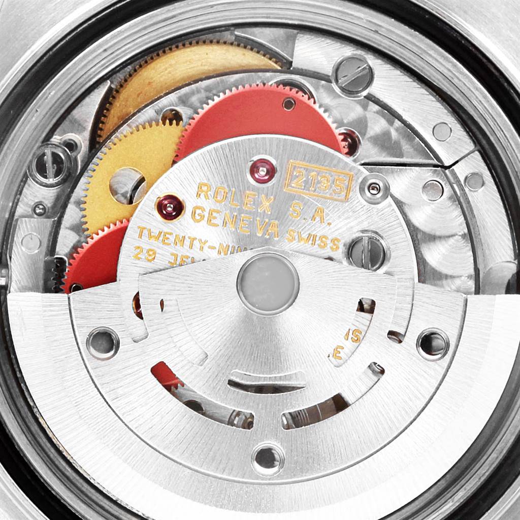 This image shows a close-up view of the internal mechanism of a Rolex Yacht-Master 69623 Women's Steel and Gold (two tone) Grey Dial 69623 Women's Steel and Gold (two tone) Grey Dial watch, highlighting gears and inscriptions.