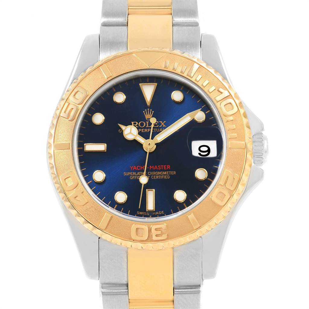 The Rolex Yacht-Master 168623 Men
s Steel and Gold (two tone) Blue Dial 168623 Men
s Steel and Gold (two tone) Blue Dial watch is shown from a front angle, highlighting its gold bezel, dark blue dial, and two-tone metal bracelet.