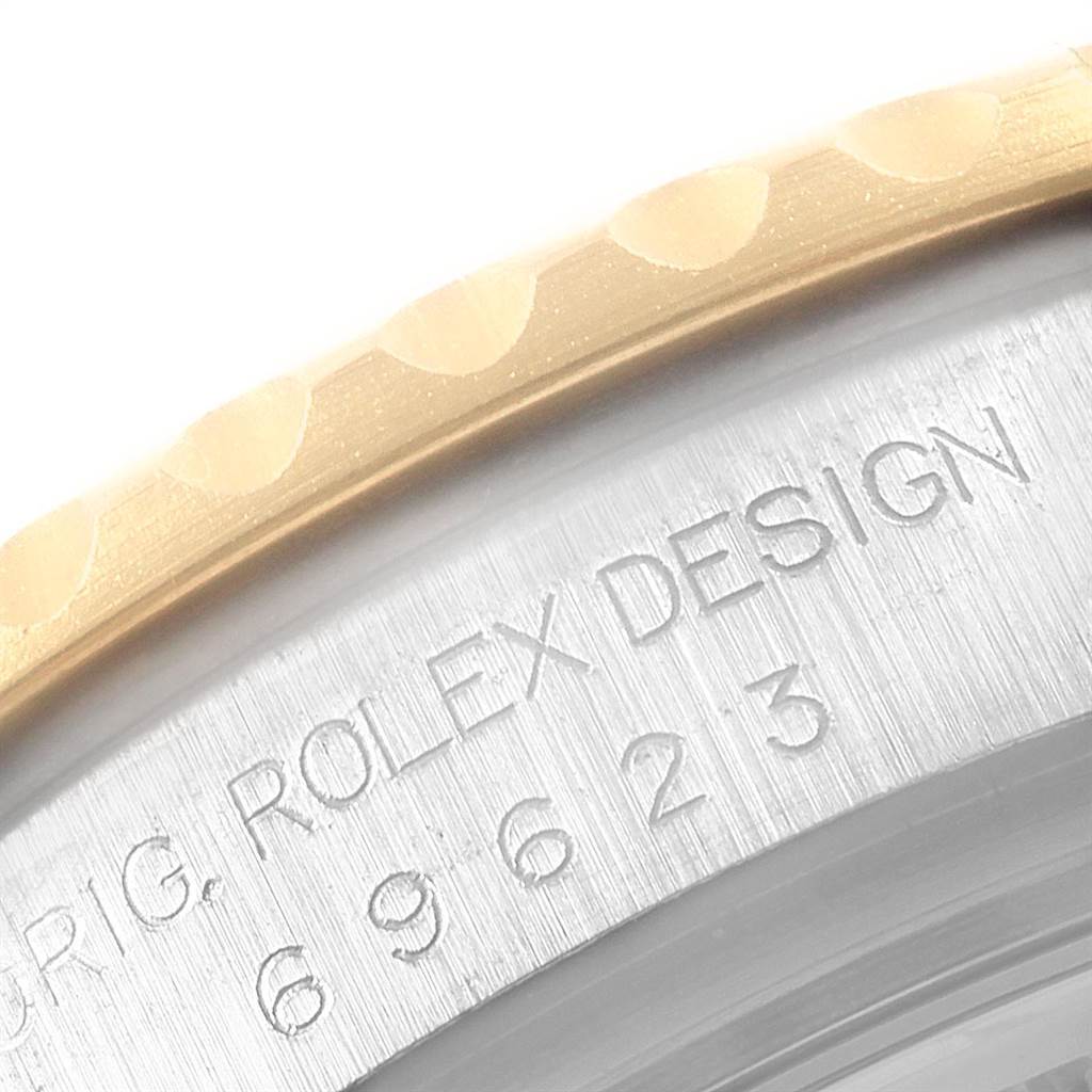 The image shows a close-up of the side of a Rolex Yacht-Master 69623 Women's Steel and Gold (two tone) Blue Dial 69623 Women's Steel and Gold (two tone) Blue Dial watch, highlighting the engraved Rolex design and part of the bezel.