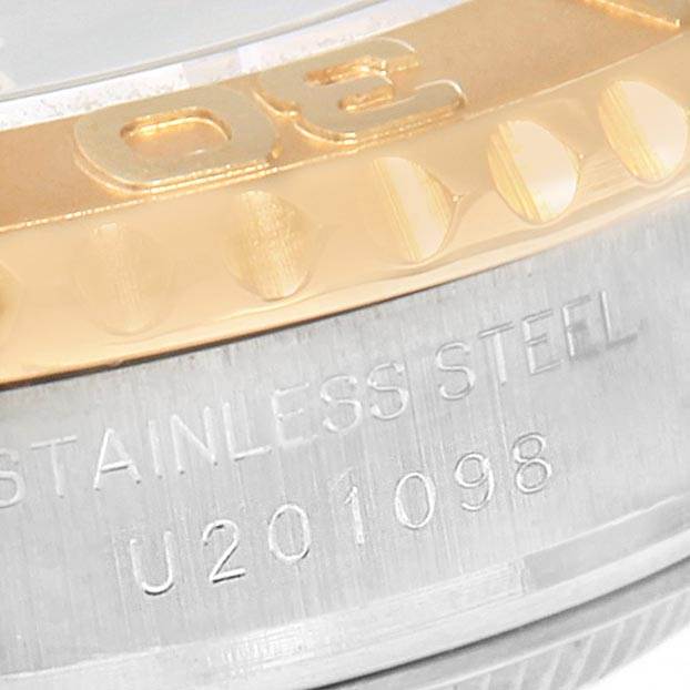 The image shows a close-up of the Rolex Yacht-Master 69623 Women's Steel and Gold (two tone) Blue Dial 69623 Women's Steel and Gold (two tone) Blue Dial watch, focusing on its stainless steel and gold bezel with engraved details.