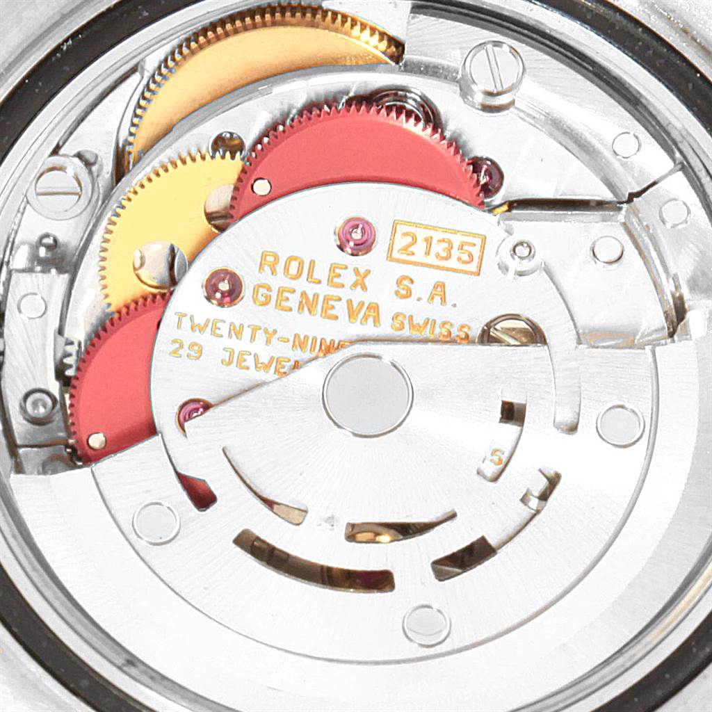 This image shows the intricate internal components of a Rolex Yacht-Master 69623 Women's Steel and Gold (two tone) Blue Dial 69623 Women's Steel and Gold (two tone) Blue Dial watch, specifically the movement and gears.