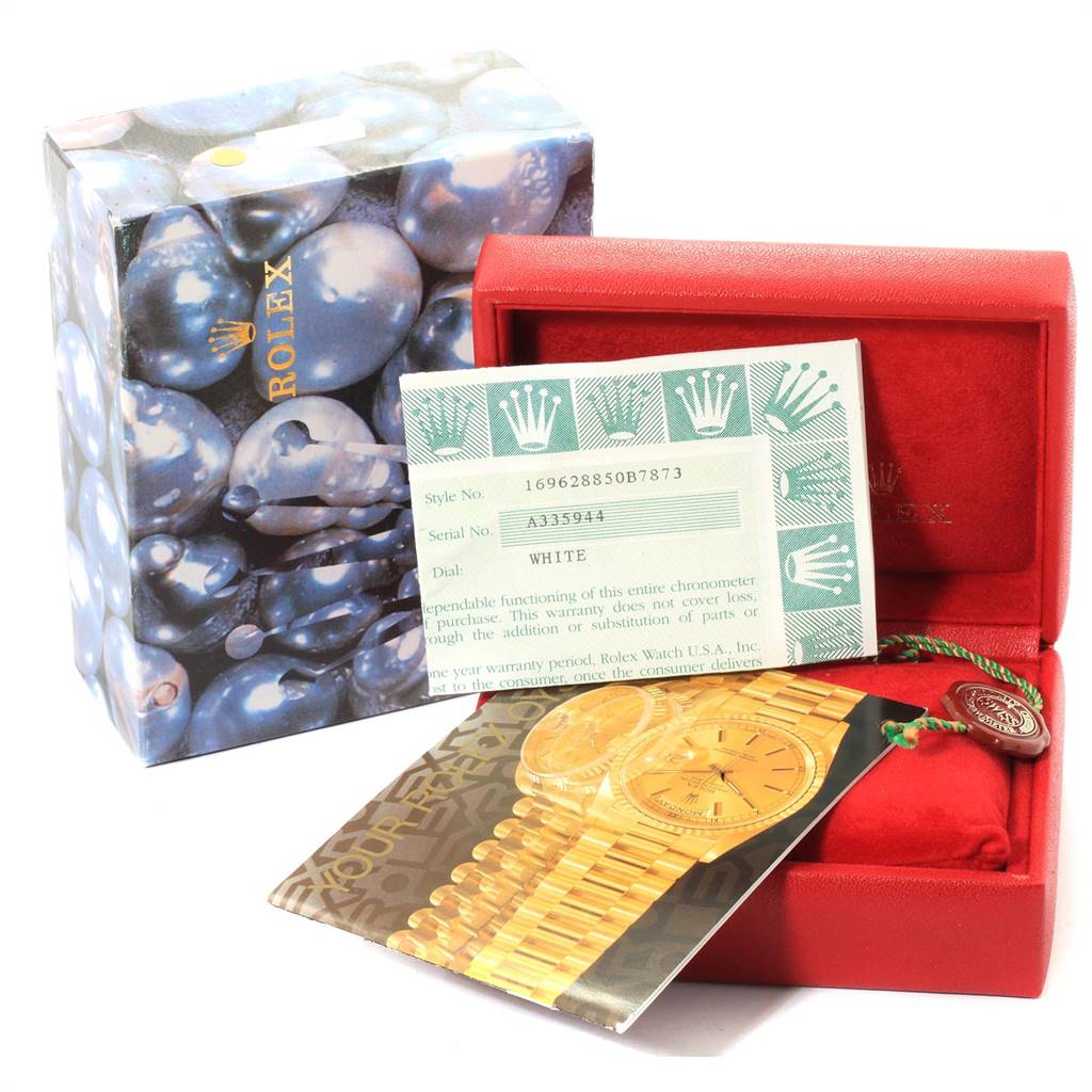 The image shows the packaging, warranty card, and brochures of a Rolex Yacht-Master 169628 Women's Yellow Gold White Dial 169628 Women's Yellow Gold White Dial watch.