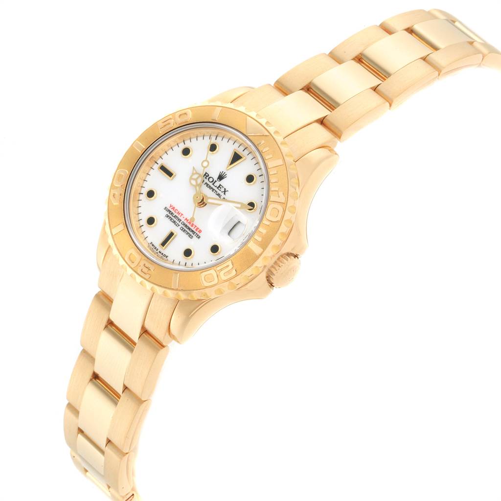 The image shows a Rolex Yacht-Master 169628 Women's Yellow Gold White Dial 169628 Women's Yellow Gold White Dial watch at a slight angle, showcasing its gold bracelet, bezel, crown, and white dial.