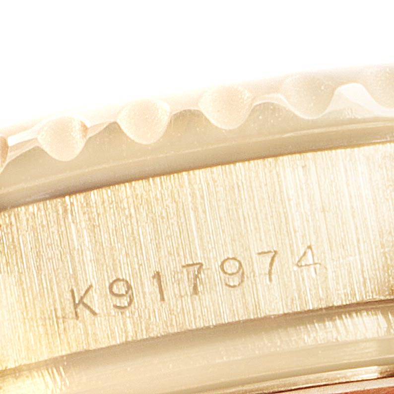 This close-up image shows the engraved serial number on the case of a Rolex Yacht-Master 169628 Women's Yellow Gold Mother of Pearl Dial 169628 Women's Yellow Gold Mother of Pearl Dial watch.