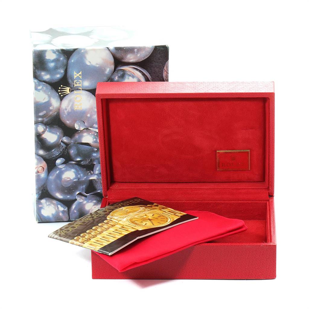 The image shows an open red Rolex box with a booklet and red pouch, for the Yacht-Master model.