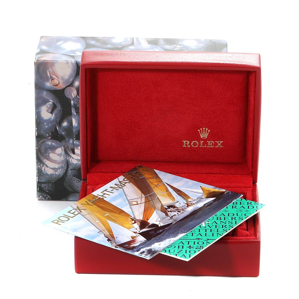 The image shows a red Rolex box with booklets for the Yacht-Master model by Rolex, with part of its packaging visible.