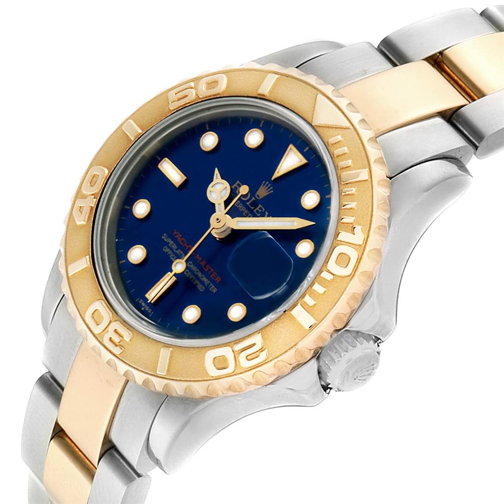 The image shows a tilted close-up view of a Rolex Yacht-Master 169623 Women's Steel and Gold (two tone) Blue Dial 169623 Women's Steel and Gold (two tone) Blue Dial watch, highlighting its bezel, dial, and part of the bracelet.