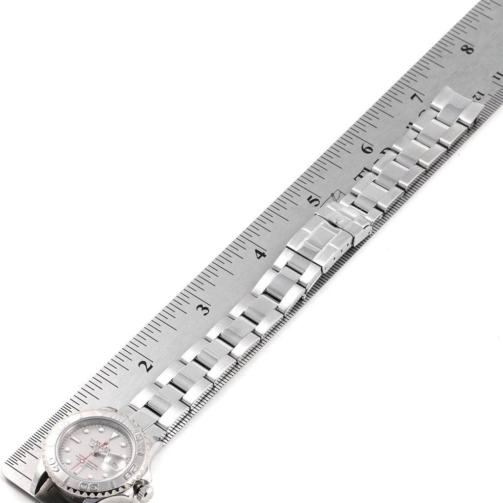 The image shows a Rolex Yacht-Master 169622 Women's Stainless Steel Silver Dial 169622 Women's Stainless Steel Silver Dial watch placed beside a ruler, highlighting its dial and metal bracelet.