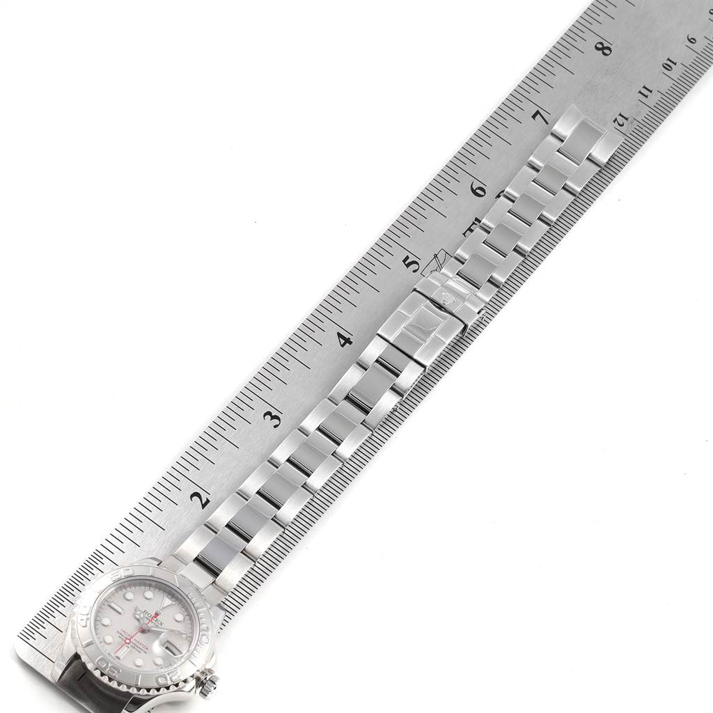 The image shows the Rolex Yacht-Master 169622 Women
s Stainless Steel Silver Dial 169622 Women
s Stainless Steel Silver Dial watch face partially along with the band measured against a ruler.