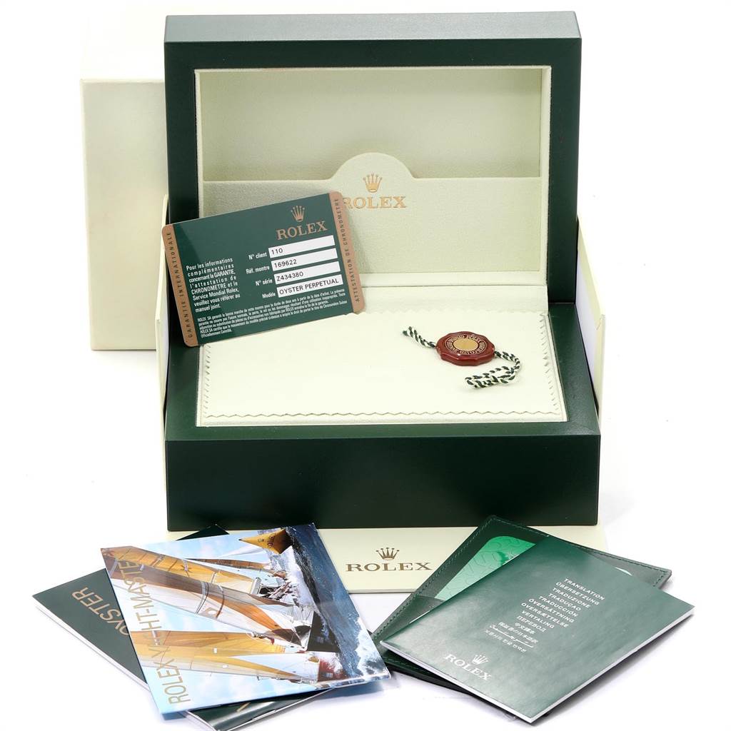 The image shows the open Rolex Yacht-Master 169622 Women's Stainless Steel Silver Dial 169622 Women's Stainless Steel Silver Dial watch box with warranty card, manuals, and a hang tag.