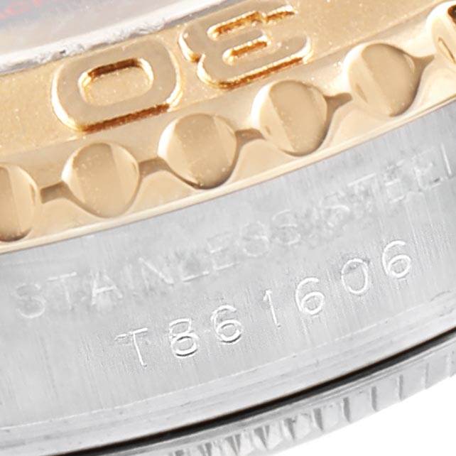 The image shows a close-up of the bezel and part of the case of a Rolex Yacht-Master 69623 Women's Steel and Gold (two tone) Blue Dial 69623 Women's Steel and Gold (two tone) Blue Dial watch, highlighting the stainless steel and serial number.