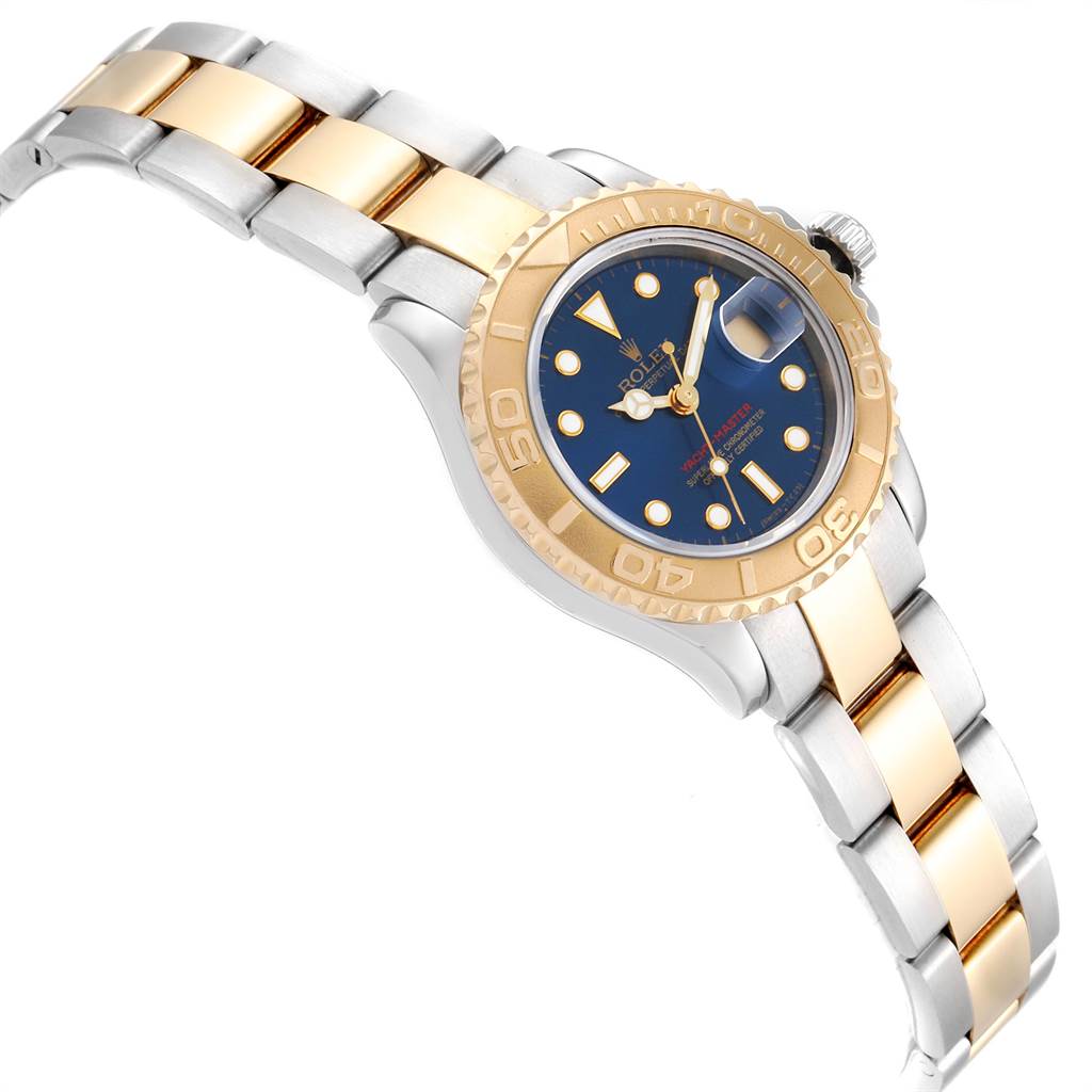 The image shows a Rolex Yacht-Master 69623 Women's Steel and Gold (two tone) Blue Dial 69623 Women's Steel and Gold (two tone) Blue Dial watch at an angled view, displaying its gold and silver bracelet, gold bezel, and blue dial.