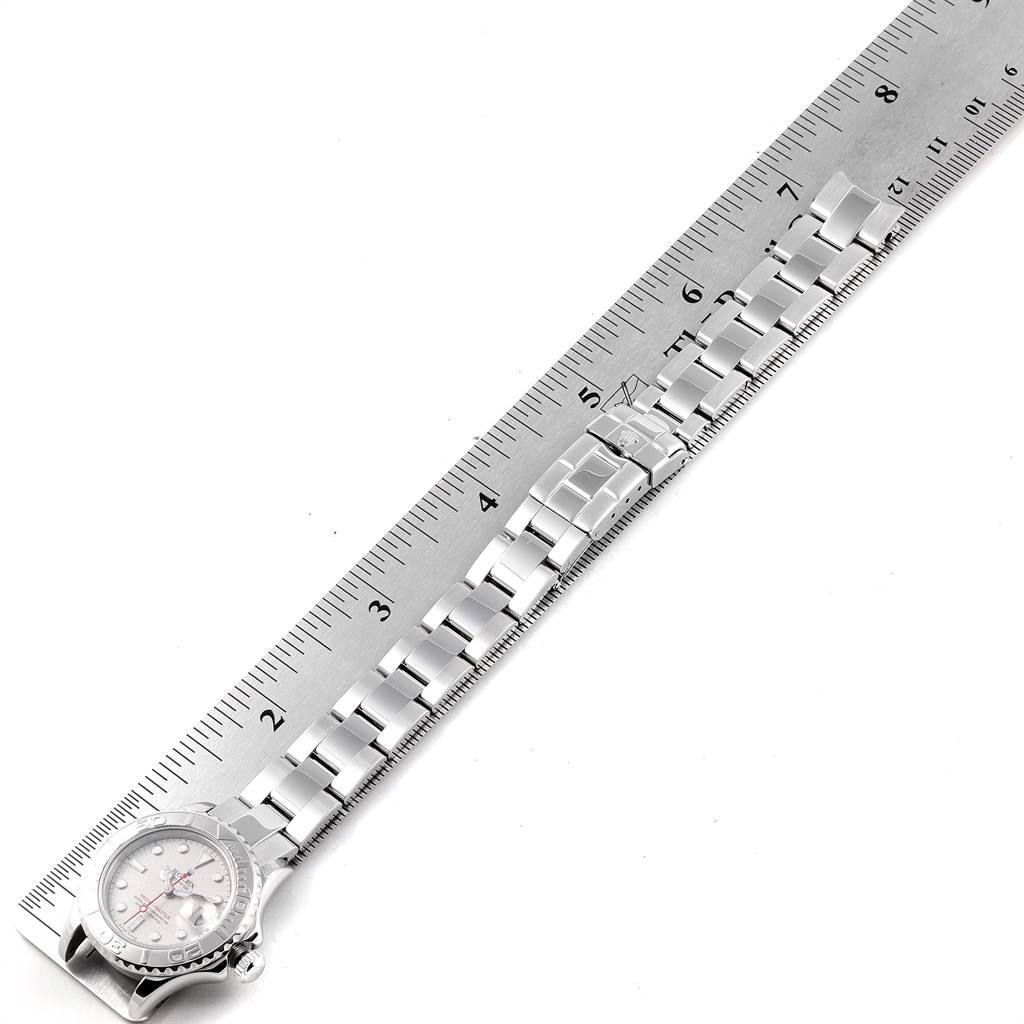 The image shows a Rolex Yacht-Master 169622 Women's Stainless Steel Silver Dial 169622 Women's Stainless Steel Silver Dial watch with the face and entire bracelet laid flat beside a ruler measuring its length.