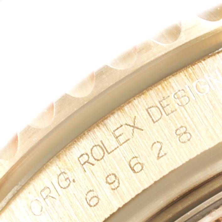 Close-up of the bezel and engravings on the Rolex Yacht-Master 69628 Women's Yellow Gold Champagne Dial 69628 Women's Yellow Gold Champagne Dial watch.