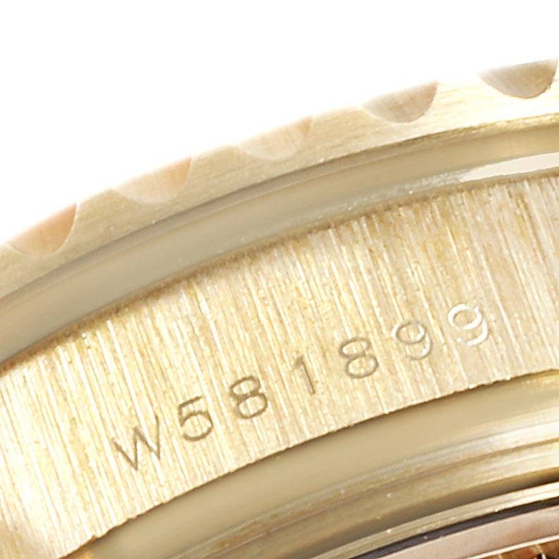 This close-up image shows the engraved serial number on the side of the Rolex Yacht-Master 69628 Women's Yellow Gold Champagne Dial 69628 Women's Yellow Gold Champagne Dial watch case.
