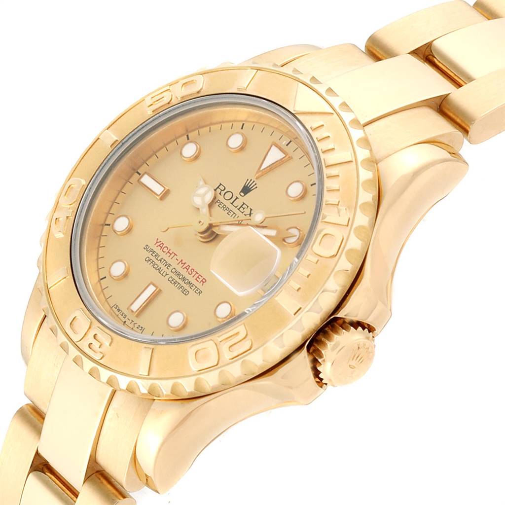 The image shows a close-up angle of a Rolex Yacht-Master 69628 Women's Yellow Gold Champagne Dial 69628 Women's Yellow Gold Champagne Dial watch, highlighting the face, bezel, crown, and part of the bracelet.