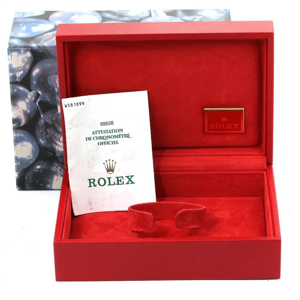 This image shows the open red box of a Rolex Yacht-Master 69628 Women's Yellow Gold Champagne Dial 69628 Women's Yellow Gold Champagne Dial with the official certification papers inside.