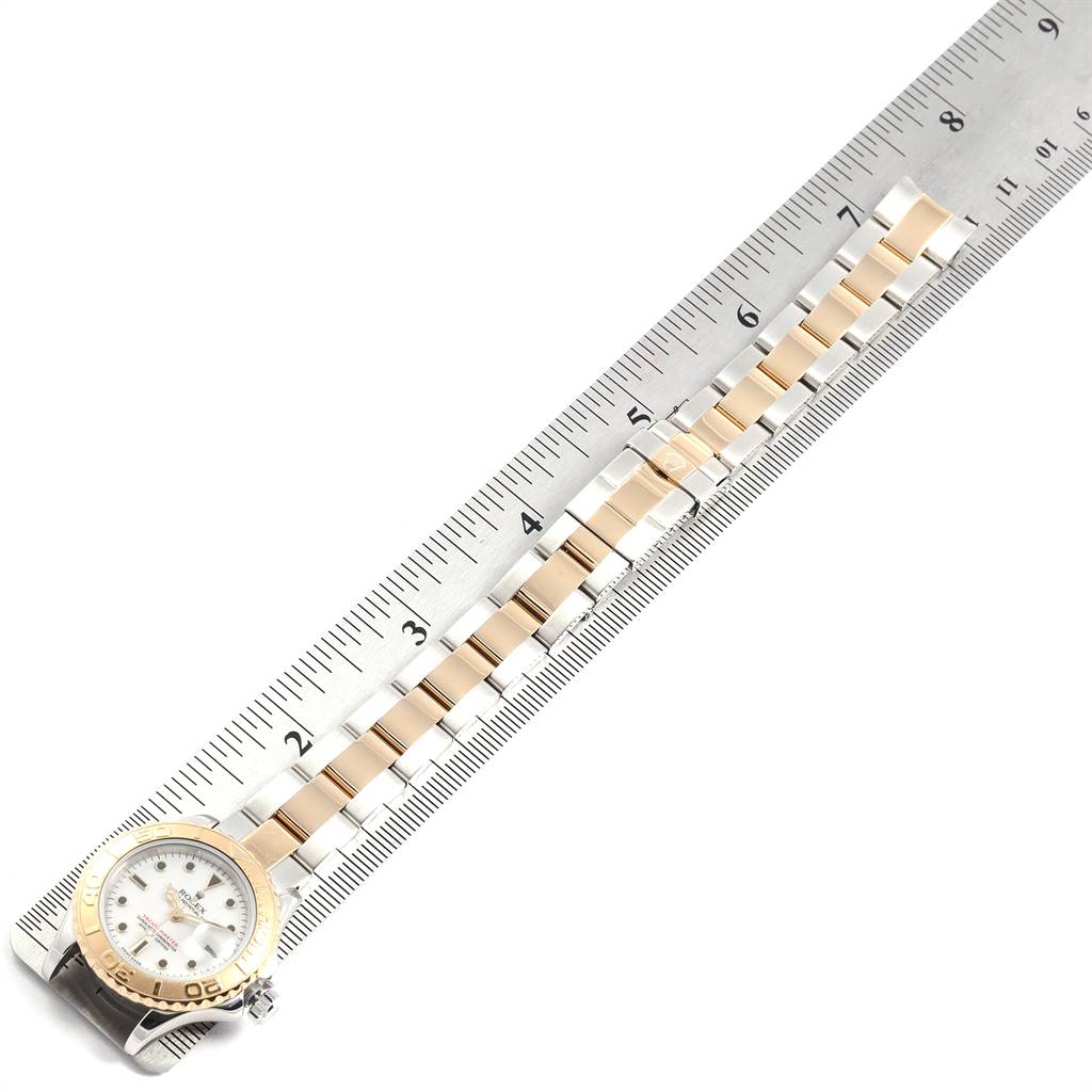 The image shows a Rolex Yacht-Master 169623 Women's Steel and Gold (two tone) White Dial 169623 Women's Steel and Gold (two tone) White Dial watch laid against a ruler, displaying the face and bracelet.