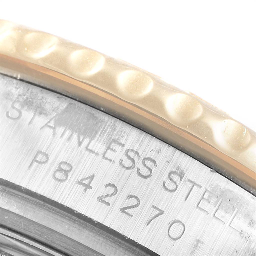 The image shows a close-up of the Rolex Yacht-Master 169623 Women's Steel and Gold (two tone) White Dial 169623 Women's Steel and Gold (two tone) White Dial watch's stainless steel case with part of the bezel and engraved serial number visible.