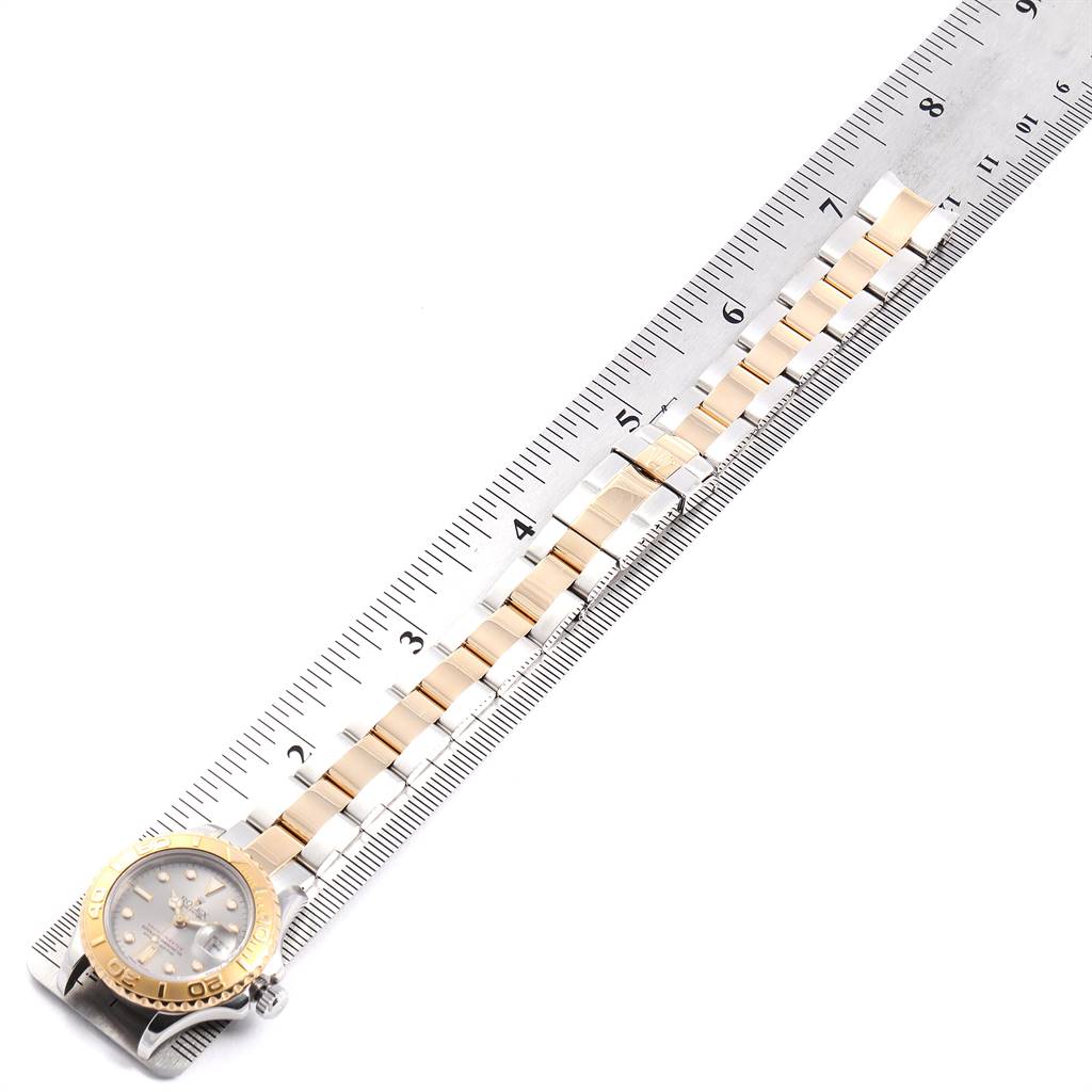The image shows a Rolex Yacht-Master 69623 Women's Steel and Gold (two tone) Grey Dial 69623 Women's Steel and Gold (two tone) Grey Dial watch fully extended, with both the watch face and bracelet against a ruler.
