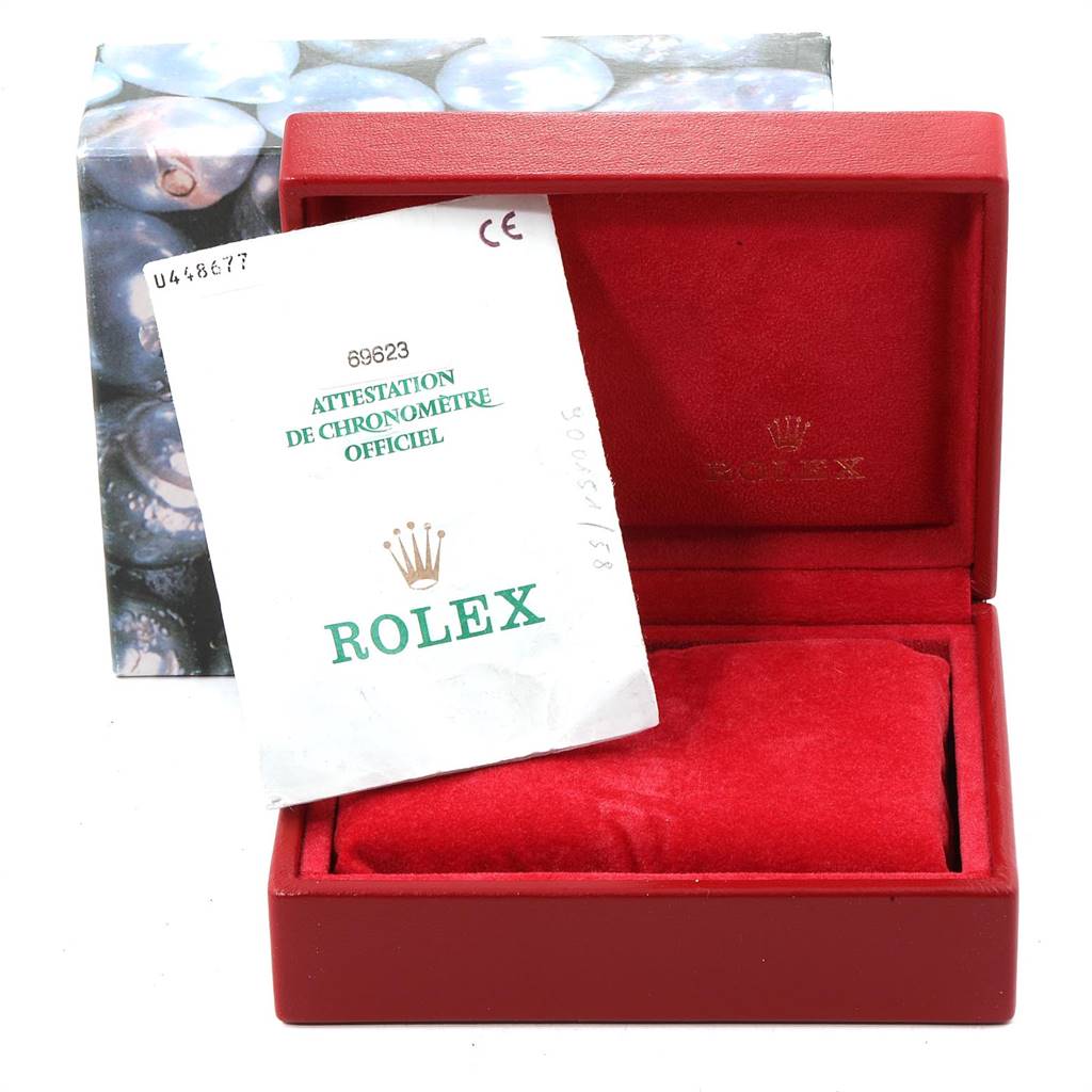 The image shows a Rolex Yacht-Master 69623 Women's Steel and Gold (two tone) Grey Dial 69623 Women's Steel and Gold (two tone) Grey Dial watch box with a certificate of authenticity placed inside.