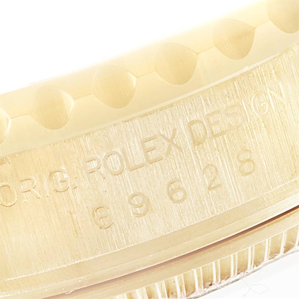 The image shows a close-up, angled view of the edge and engraved details of the bezel of a Rolex Yacht-Master 169628 Women's Yellow Gold Mother of Pearl Dial 169628 Women's Yellow Gold Mother of Pearl Dial watch.